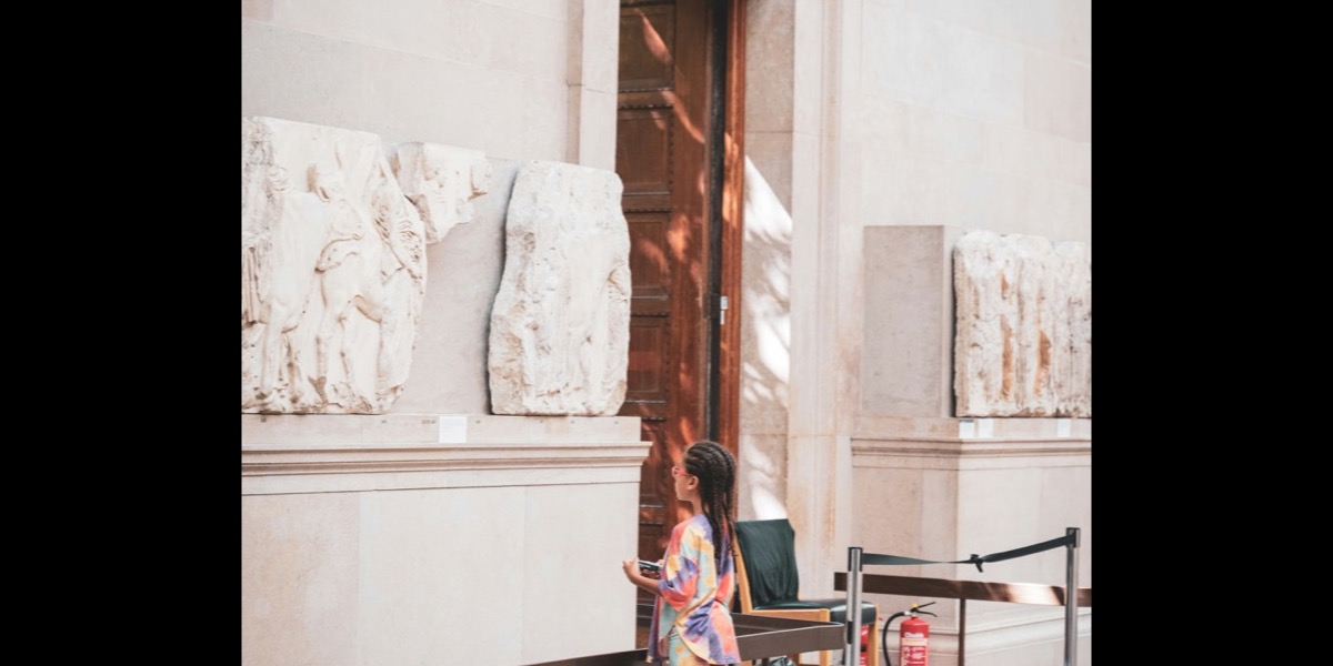 Child at the British Museum looking at ancient sculptures